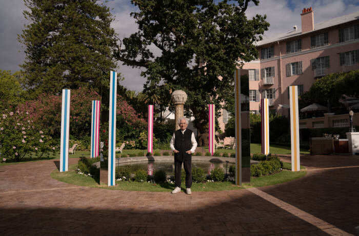 Man standing in front of building with colourful pillars