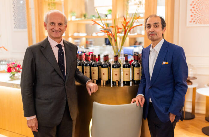 Two men standing in front of wines